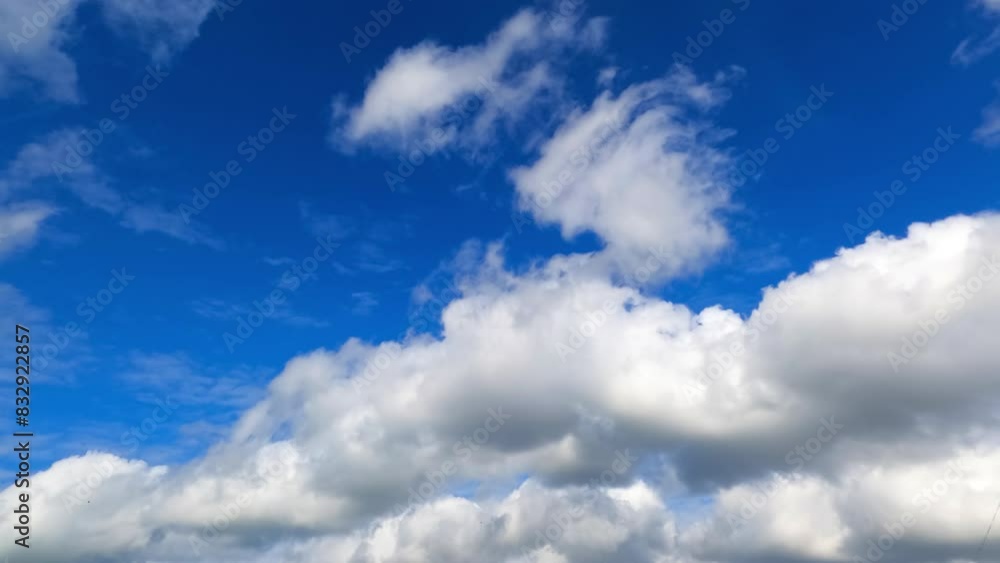 Soft fluffy clouds in the amazing azure sky. Cirrocumulus and cumulus cloudscape arrives and covers the horizon. Low angle view. Timelapse. Soft fluffy clouds in the amazing azure sky. Cirrocumulus and cumulus cloudscape arrives and covers the horizon. Low angle view. Timelapse.