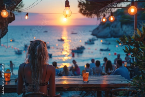 Scenic seaside bar view with sunset and festive hanging lights creating a warm and inviting atmosphere © LifeMedia