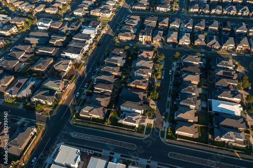 Obraz na plátně Late afternoon aerial view of streets lined with similar sized modern Australian brick veneer homes in the outer suburbs of Sydney, Australia