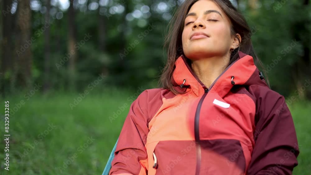 Happy woman relaxing in the nature after hiking Happy woman relaxing in the nature after hiking
