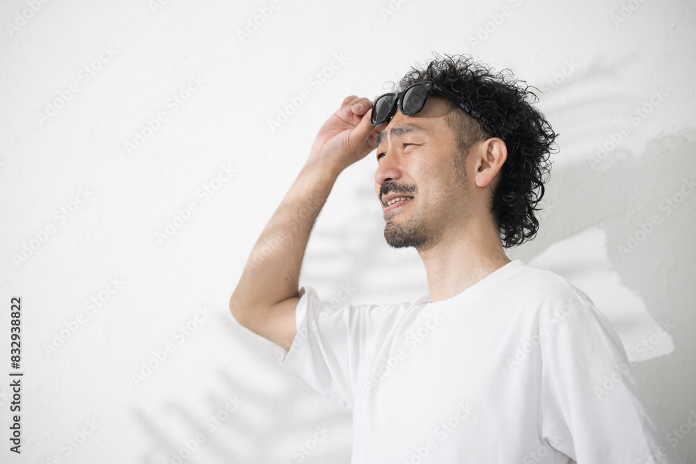 Man wearing sunglasses because the sun is blinding Man wearing sunglasses because the sun is blinding