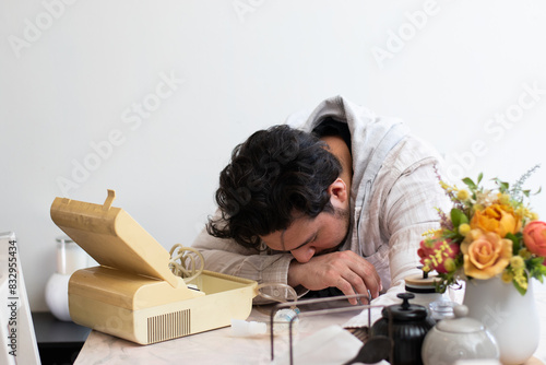 Person with respiratory problems in the living room trying to used a old nebulizer and get confused