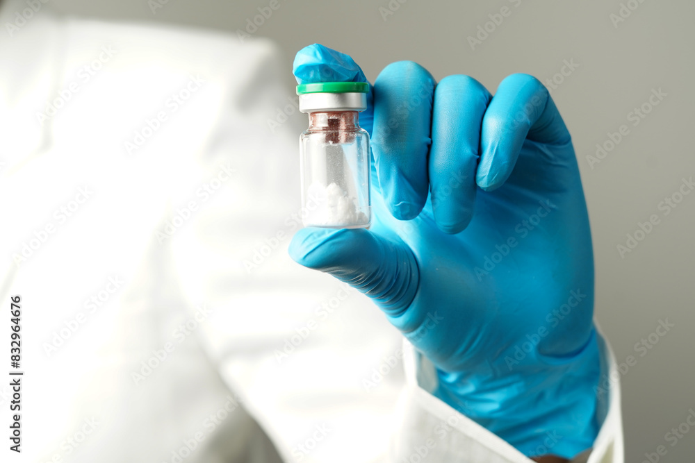 virus vaccine bottle for injection in hand of doctor or Technician scientist virus vaccine bottle for injection in hand of doctor or Technician scientist