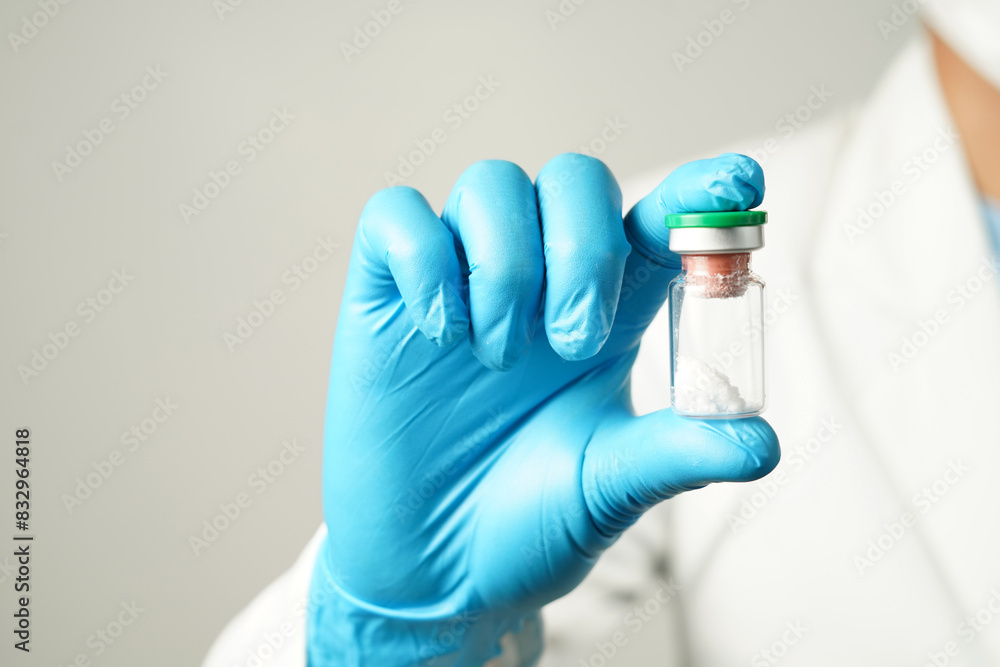 virus vaccine bottle for injection in hand of doctor or Technician scientist virus vaccine bottle for injection in hand of doctor or Technician scientist