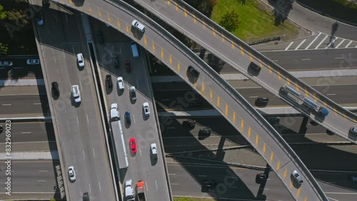 overhead aerial view of multi lane highway system with multi lanes and off and off ramps