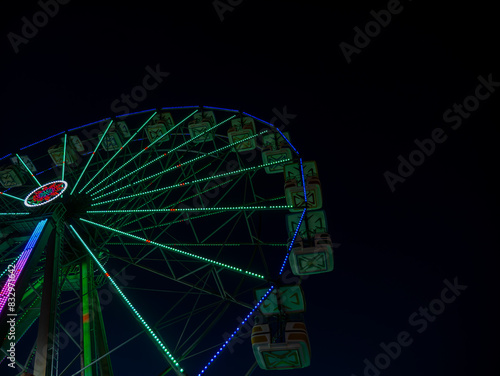 Partial view of a colorful ferris wheel at the Virginia Beach Boardwalk.
