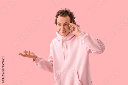 Young man talking by mobile...