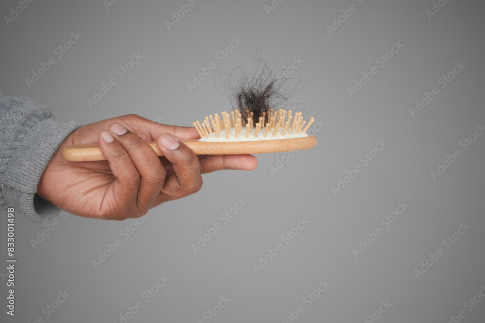 Naklejka premium man hold his list hair close up 