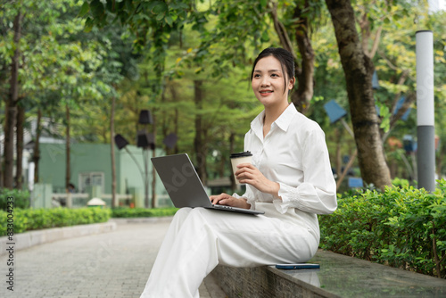 Portrait of young Asian businesswoman in the park
