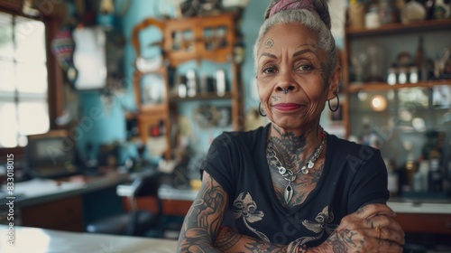 Portrait of african old woman tattoo artist at studio tattoo photo