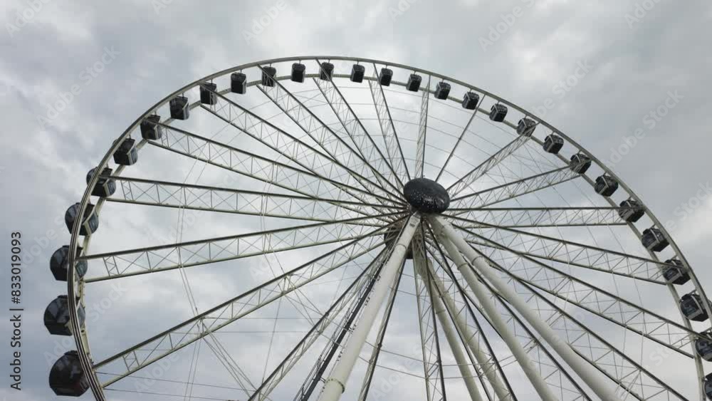 Giant Ferris wheel in Miami's BaySide against a cloudy sky Giant Ferris wheel in Miami's BaySide against a cloudy sky