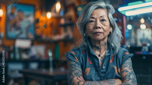 Portrait of a old woman tattoo artist at studio tattoo