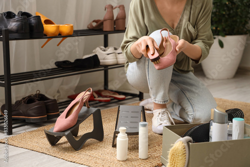 Woman cleaning stylish sued...