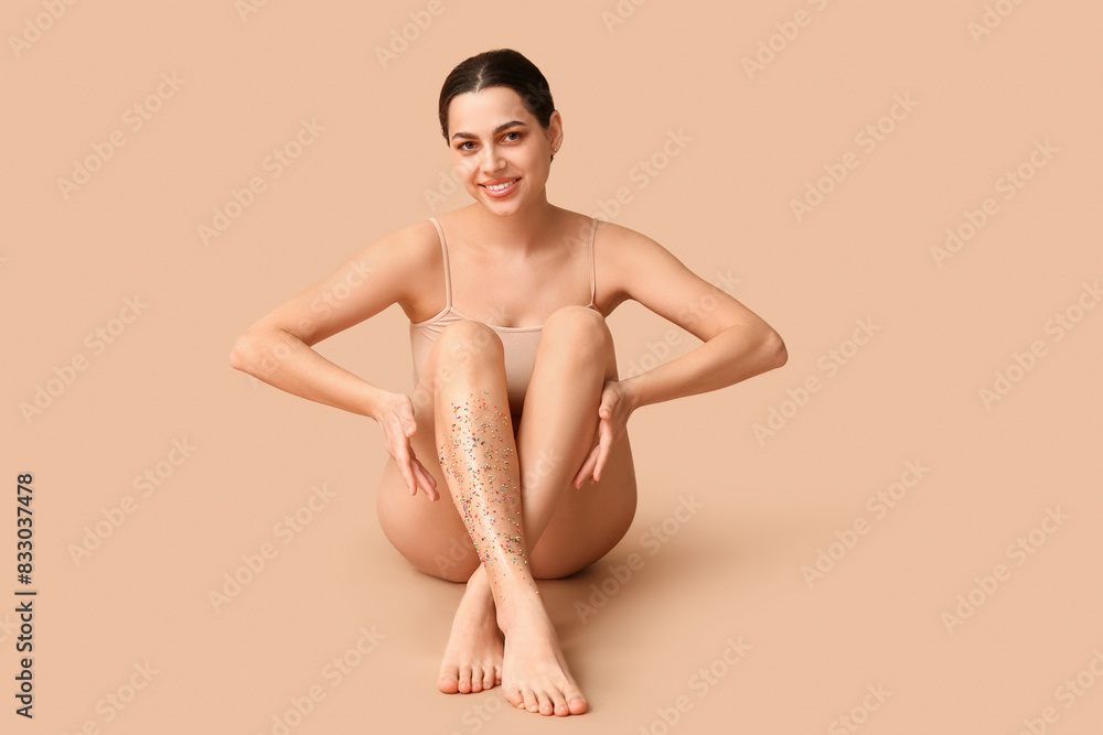 Beautiful young happy woman with colorful sprinkles on beige background. Depilation concept Beautiful young happy woman with colorful sprinkles on beige background. Depilation concept