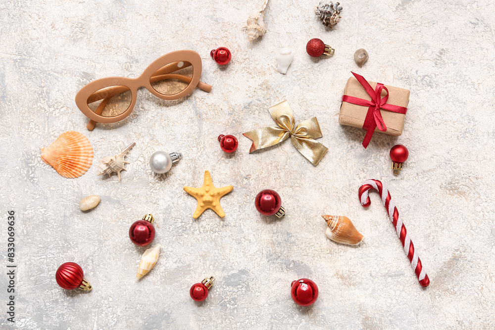 Sunglasses and shells with Christmas decor on white grunge background. Top view Sunglasses and shells with Christmas decor on white grunge background. Top view