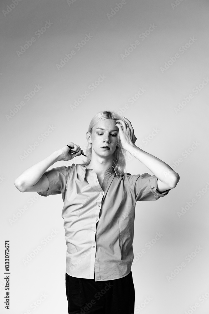 Studio photo of a man with make up on one half of face