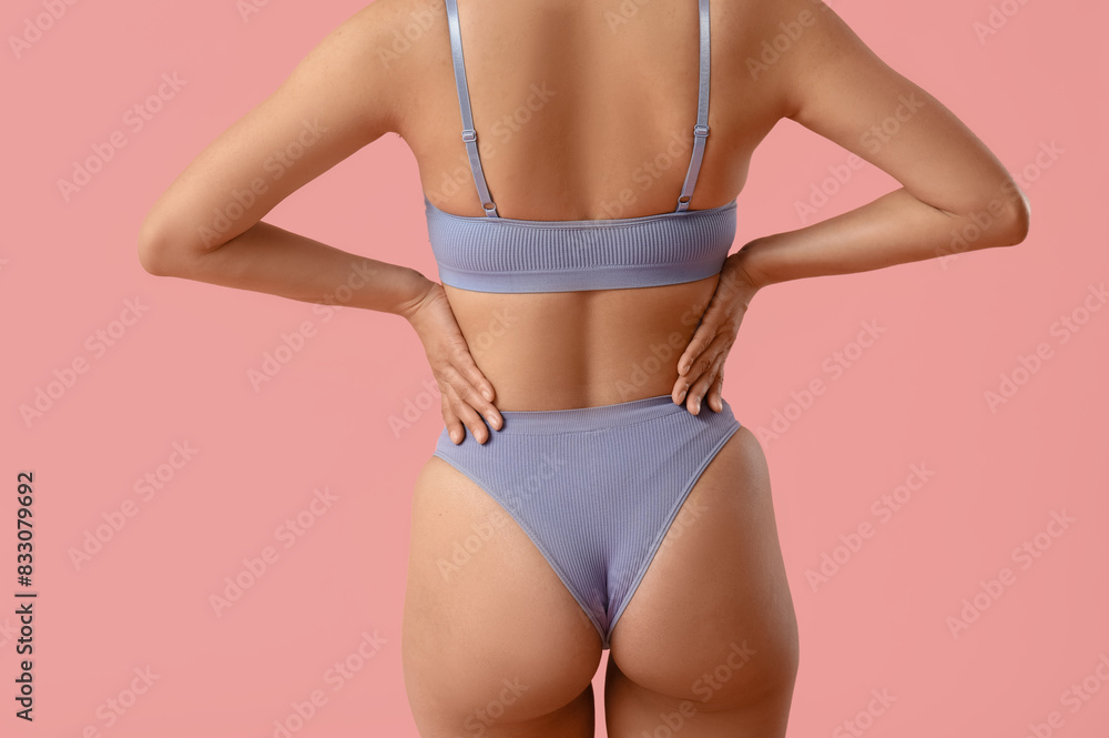 Beautiful young African-American woman in stylish underwear on pink background, back view Beautiful young African-American woman in stylish underwear on pink background, back view