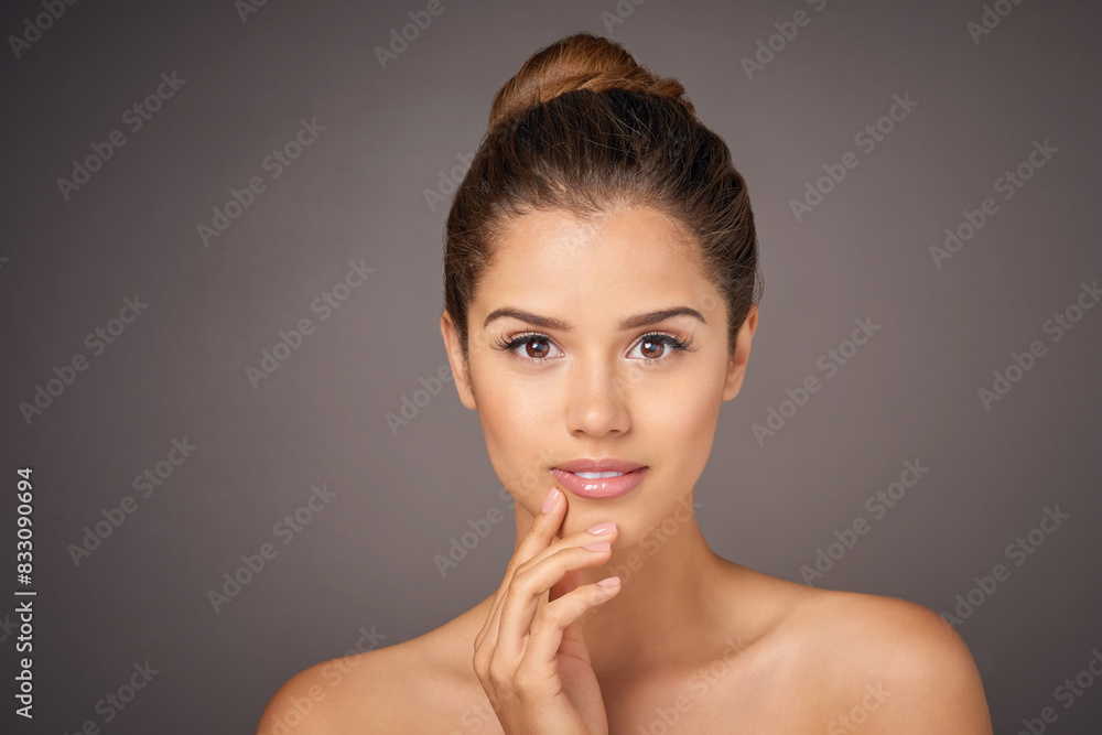 Woman, skincare and portrait in studio with self care for healthy glow on face. Clean, beauty and girl with natural cosmetics from dermatology for hygiene, wellness or smile in grey background Woman, skincare and portrait in studio with self care for healthy glow on face. Clean, beauty and girl with natural cosmetics from dermatology for hygiene, wellness or smile in grey background