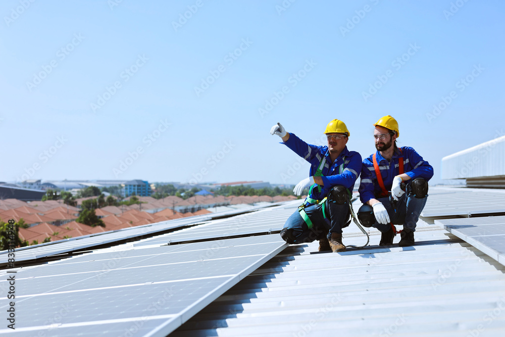 Two caucasian workers looking at positions sunlight to plan for install solar panels on industrial factory rooftop. Two caucasian workers looking at positions sunlight to plan for install solar panels on industrial factory rooftop.