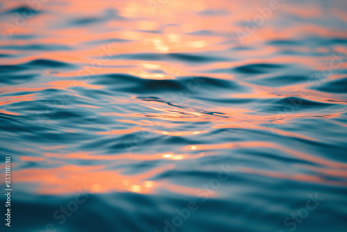Soft sunset water surface background with small blurred ripples