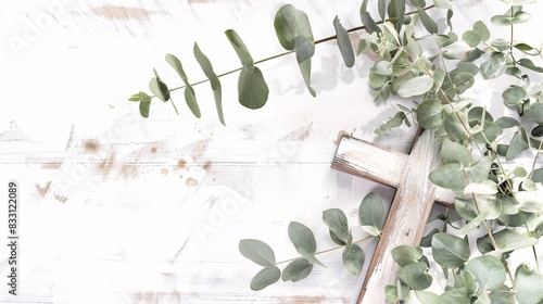 Invitation for a religious celebration featuring eucalyptus foliage and a symbolic cross for a baptism or christening ceremony. photo