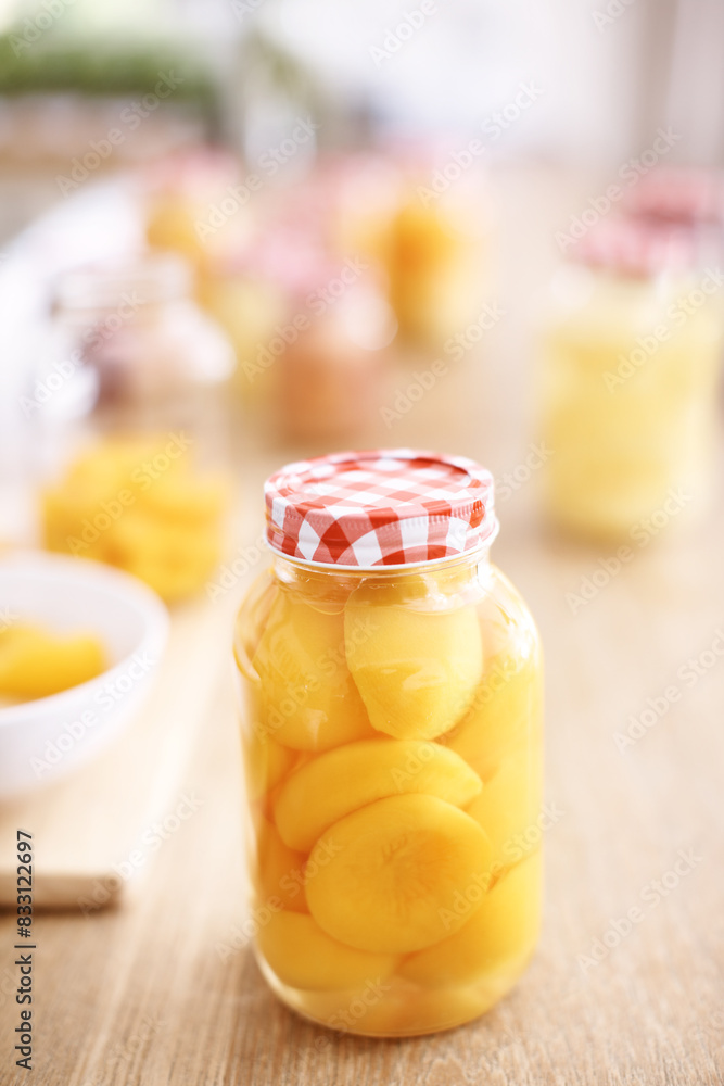 Kitchen, jar and peach on table, vegan and fruit for nutrition, healthy and glass on wood and protein. Home, countertop and preserved for diet, vitamin c and breakfast in morning, snack and food Kitchen, jar and peach on table, vegan and fruit for nutrition, healthy and glass on wood and protein. Home, countertop and preserved for diet, vitamin c and breakfast in morning, snack and food