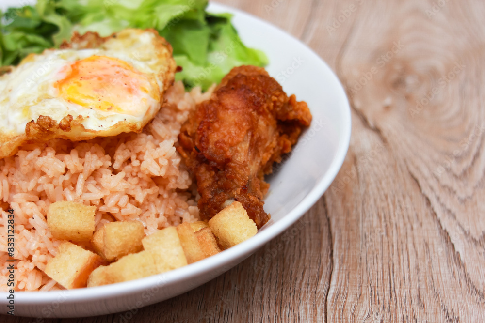 Fried rice with tomato sauce Or as we call it American fried rice Served with fried eggs, fried chicken, fresh stir-fry, and fried bread. Fried rice with tomato sauce Or as we call it American fried rice Served with fried eggs, fried chicken, fresh stir-fry, and fried bread.