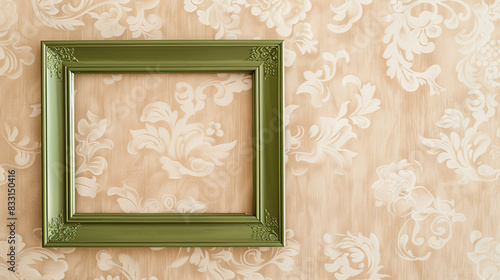 Vintage olive green frame on a beige wall, creating a natural and understated aesthetic. photo