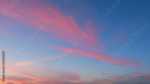 Purple cloudscape background. Dramatic pink and purple clouds at sunset. Timelapse. photo