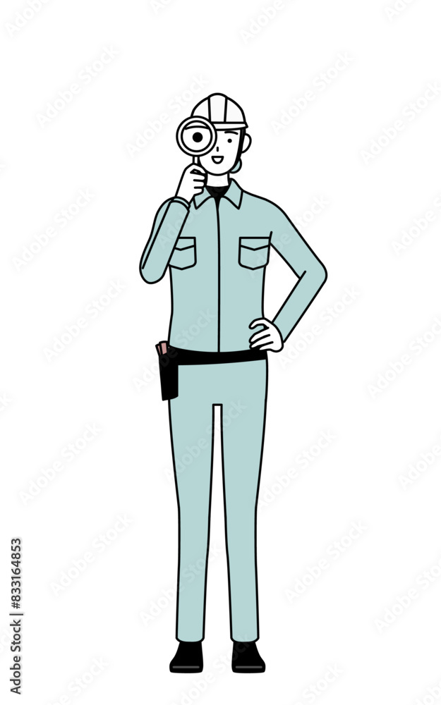 Female engineer in helmet and work wear looking through magnifying glasses Female engineer in helmet and work wear looking through magnifying glasses