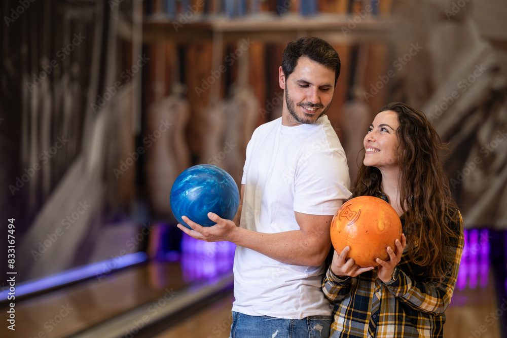 Fototapeta premium happy couple enjoying an afternoon together playing bowling