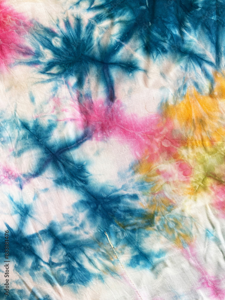 Vibrant Splash on Tie-Dye Fabric with Blue, Yellow, and Red on White Background Vibrant Splash on Tie-Dye Fabric with Blue, Yellow, and Red on White Background