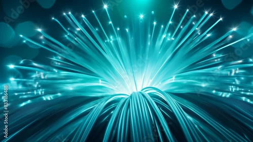 Brilliant blue fiber optic lights bursting from a central point, creating a dynamic, futuristic atmosphere. The radiant strands extend outward, symbolizing energy, connectivity, and modern technology.