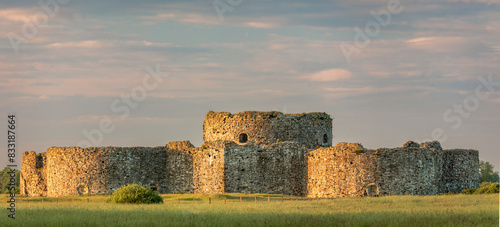 Fotografie Camber Sands castle being bathed in the evening golden hour light near Rye East