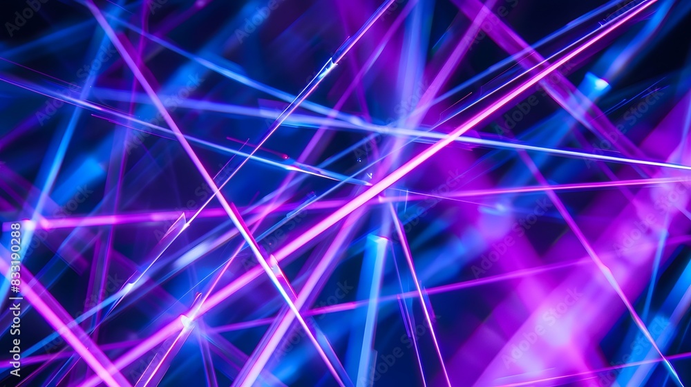 A mesmerizing display of vibrant neon laser lights in blue and purple, creating dynamic and energetic visual effects. A mesmerizing display of vibrant neon laser lights in blue and purple, creating dynamic and energetic visual effects.