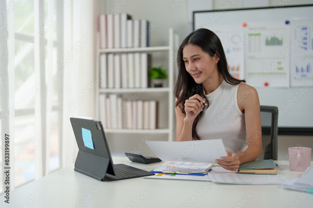 Confident businesswoman working with laptop and documents in home office, thinking, analyzing work happily. Confident businesswoman working with laptop and documents in home office, thinking, analyzing work happily.