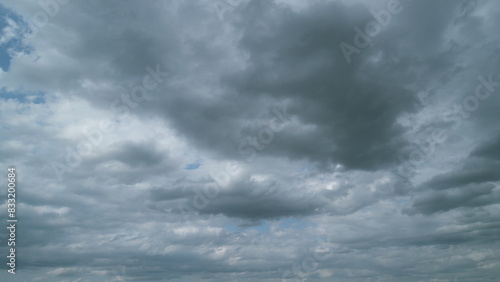 Cumulus clouds moves in the blue sky. Dark huge cloud in sky. Change of weather. Timelapse.