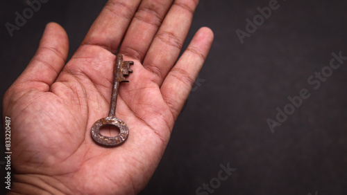 A picture of a old key in a hand 