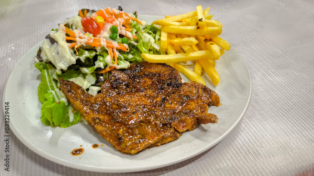 Spicy Mala Pork Neck Steak ,pork loin, pork shoulder, well-cooked spicy sauce. salad side dishes eaten raw, green oak vegetables, corn with creamy salad dressing and local style French fries Spicy Mala Pork Neck Steak ,pork loin, pork shoulder, well-cooked spicy sauce. salad side dishes eaten raw, green oak vegetables, corn with creamy salad dressing and local style French fries