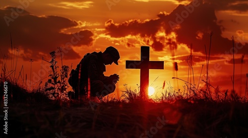 A silhouette of a soldier kneeling beside a battlefield cross, a poignant symbol of remembrance on Memorial Day © LaxmiOwl