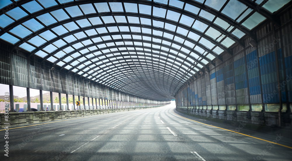 Futuristic tunnel roadway with blue glass panels Futuristic tunnel roadway with blue glass panels