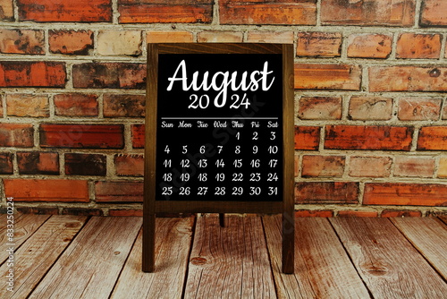 August 2024 monthly calendar on chalkboard for planning and management