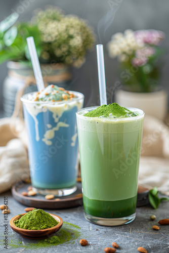 Trendy green and blue matcha drink in a glass with ice and a straw. Colorful Japanese tea latte, green and blue moon milk. Tea made from dried butterfly pea flowers and tea tree leaves with milk