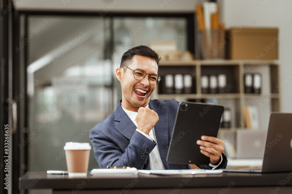 Middle-aged Asian businessman in formal suit working diligently at his desk. seasoned business and investment consultant, specializing in strategic portfolio management and financial analysis. Middle-aged Asian businessman in formal suit working diligently at his desk. seasoned business and investment consultant, specializing in strategic portfolio management and financial analysis.