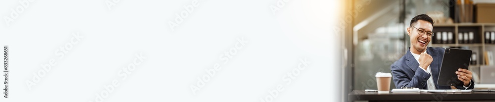 Middle-aged Asian businessman in formal suit working diligently at his desk. seasoned business and investment consultant, specializing in strategic portfolio management and financial analysis. Middle-aged Asian businessman in formal suit working diligently at his desk. seasoned business and investment consultant, specializing in strategic portfolio management and financial analysis.