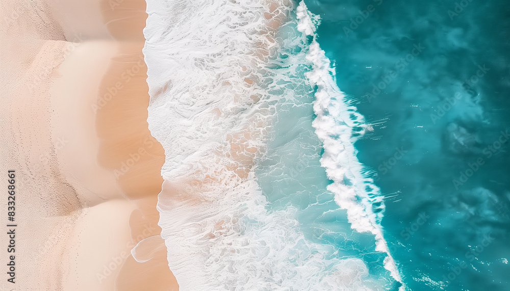 Sunlit aerial shot of tropical beach with turquoise water and white foam waves.