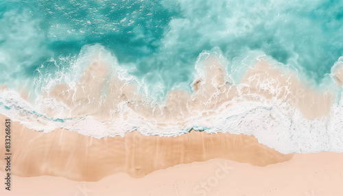Overhead view of sunny tropical beach with turquoise sea and white waves.