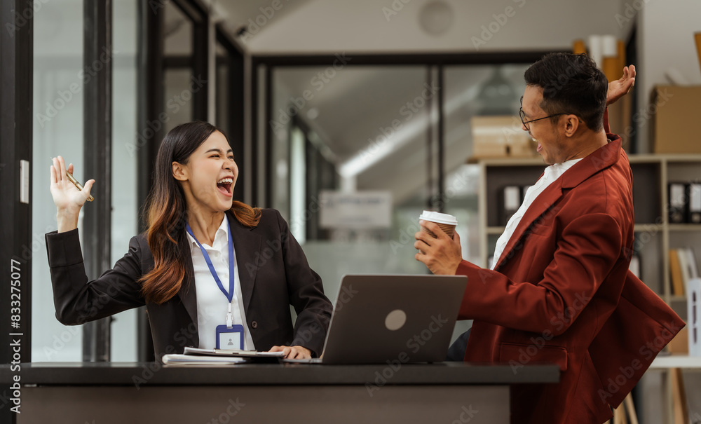 Middle-aged businessman and young Asian businesswoman diligently working at desks, managing tasks as recruitment, training, performance management, inclusive organizational culture. Middle-aged businessman and young Asian businesswoman diligently working at desks, managing tasks as recruitment, training, performance management, inclusive organizational culture.