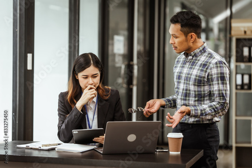 Принти на полотні Young businesswoman and other Asian individuals are seen working at desks