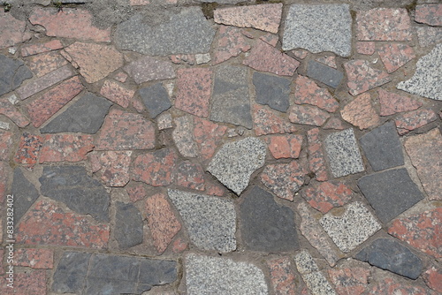 Background - crazy pavement made of multicolored polished granite stone blocks photo